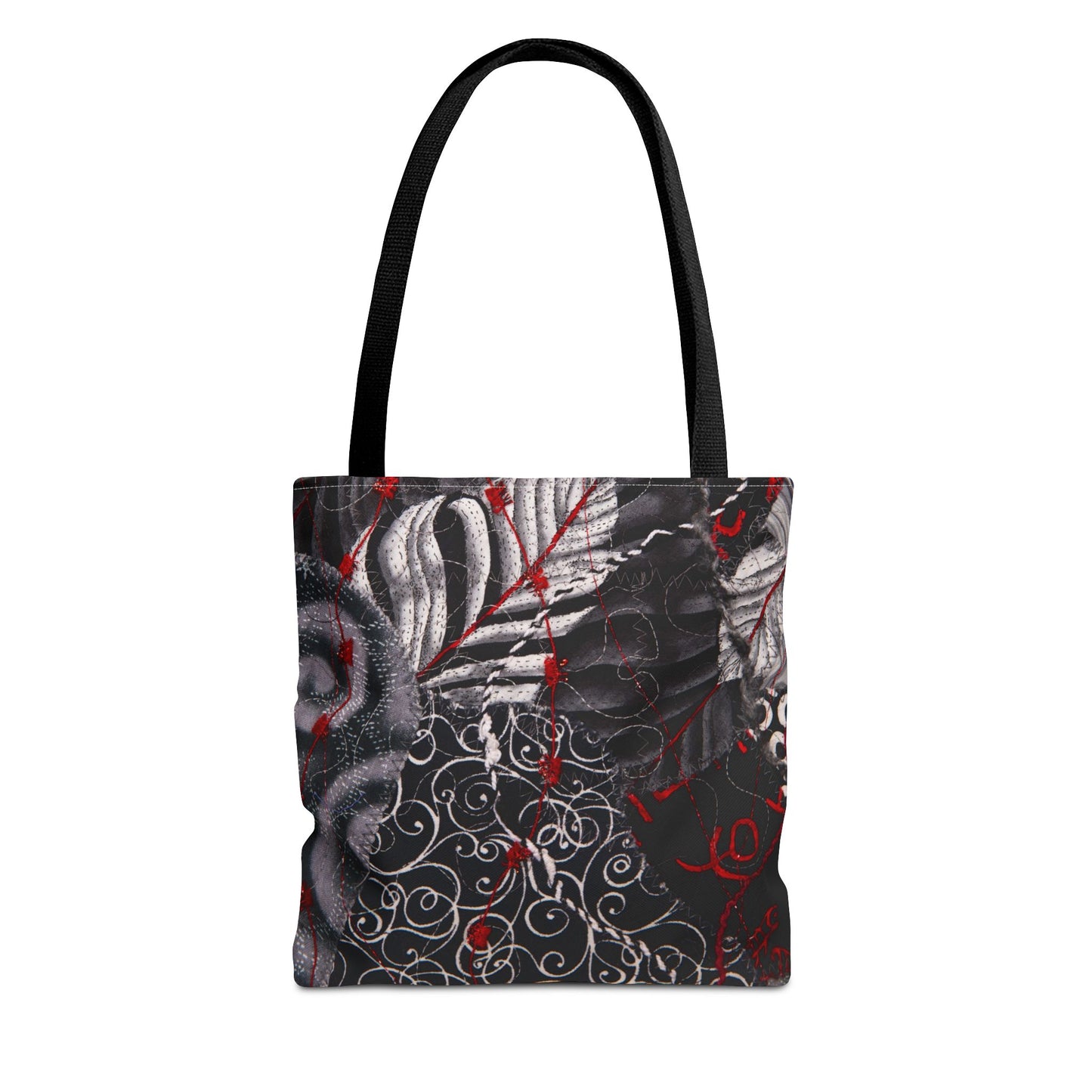 Tote bag with black handle featuring a black and white abstract design with red accents 