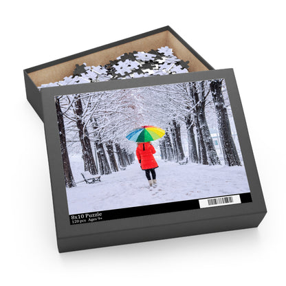 Jigsaw puzzle box with a winter scene design featuring a person in a red coat and colorful umbrella.