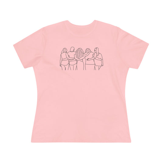 Pink t-shirt with a black line graphic of five women with different hair styles linking arms on a pink background
