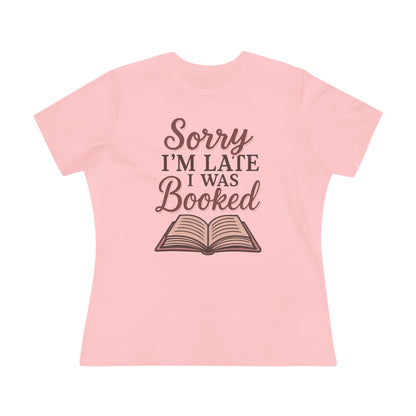 Pink t-shirt with 'Sorry I'm Late I Was Booked' text and book graphic 