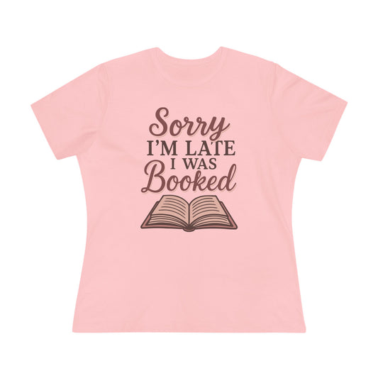 Pink t-shirt with 'Sorry I'm Late I Was Booked' text and book graphic 