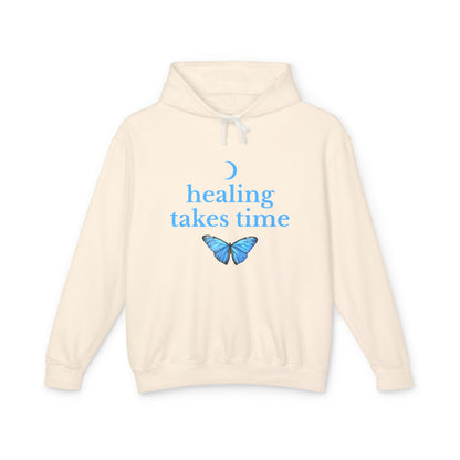 Beige hoodie with blue butterfly and text 'healing takes time' 