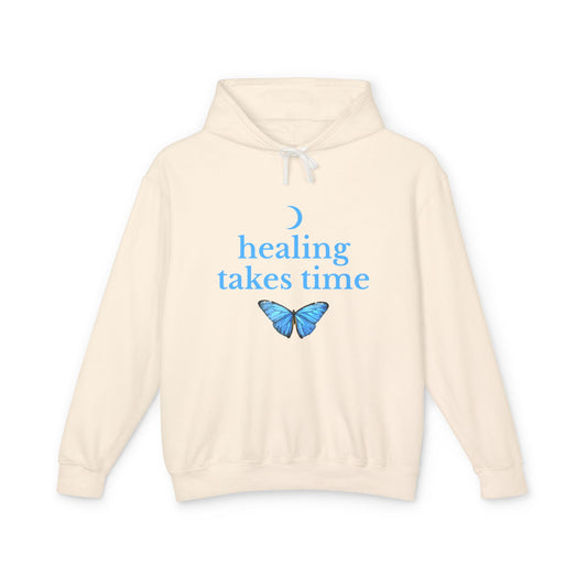 Beige hoodie with blue butterfly and text 'healing takes time' 
