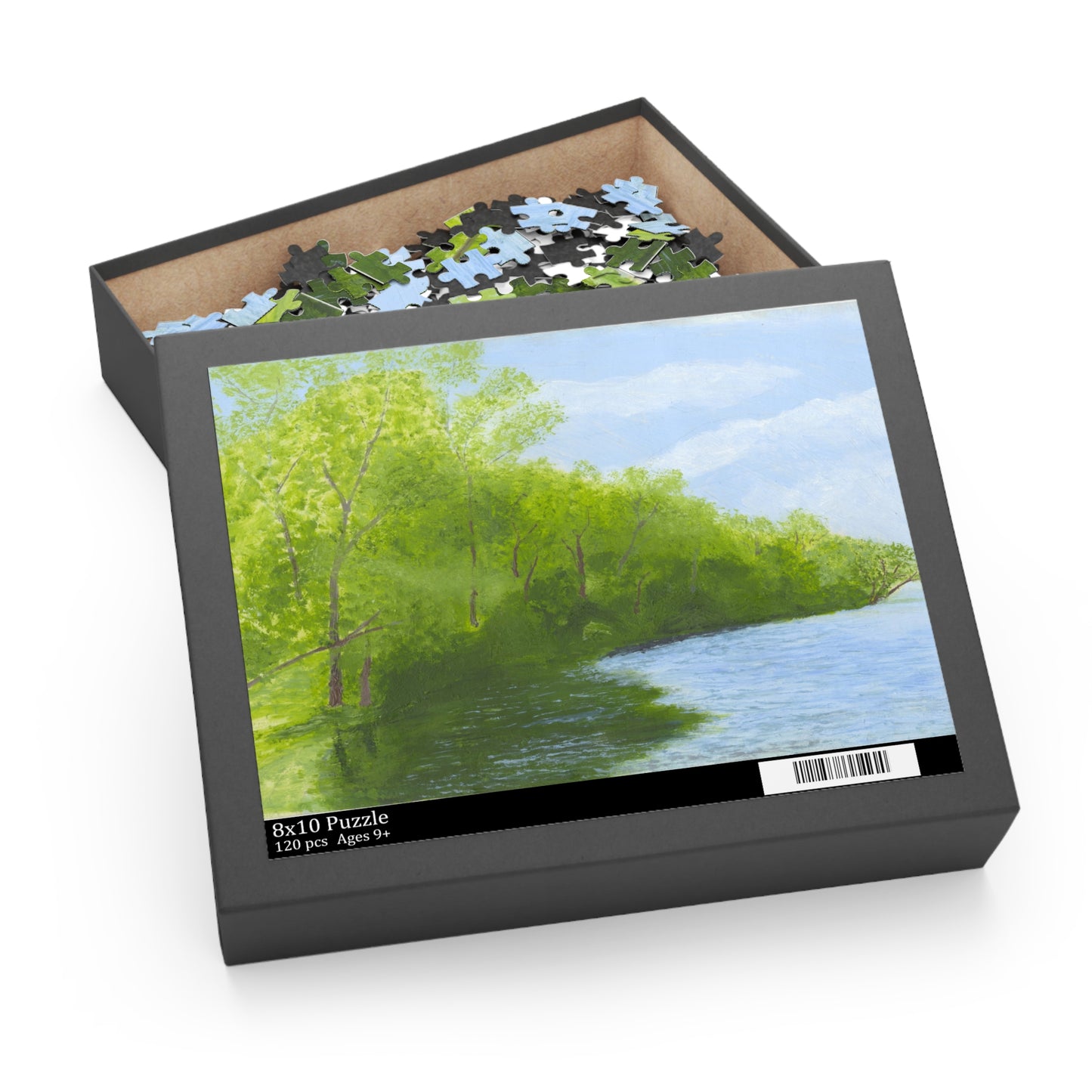 Jigsaw puzzle box with a scenic puzzle featuring trees and water 
