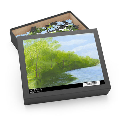 Jigsaw puzzle box with a scenic puzzle featuring trees and water 