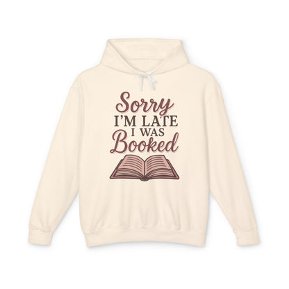Beige hoodie with 'Sorry I'm Late I Was Booked' text and book graphic 