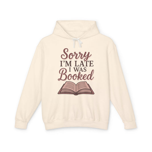 Beige hoodie with 'Sorry I'm Late I Was Booked' text and book graphic 