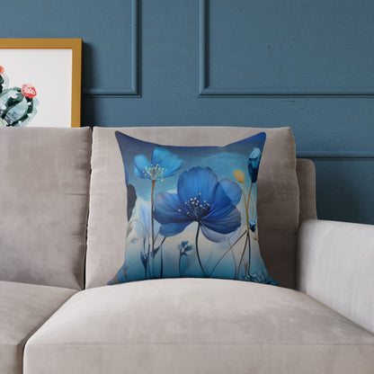 Decorative pillow with blue floral design on a gray sofa against a blue wall.