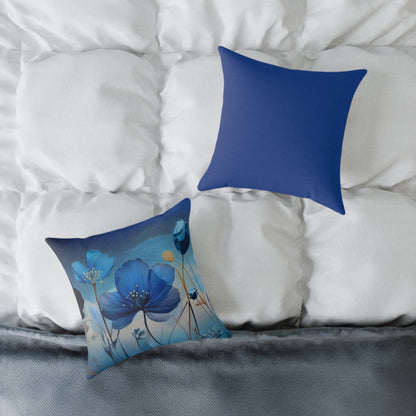 Two blue pillows, one with floral design, on a bed with white bedding.